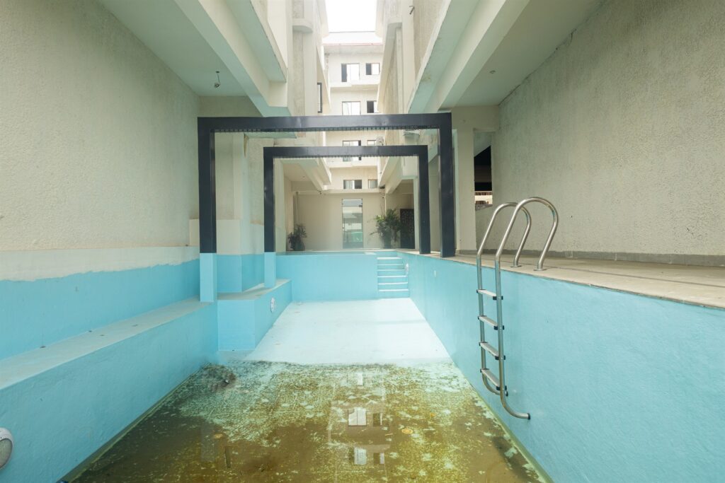 Brum Height 7: Swimming pool with metal access ladder and tiled deck